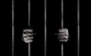 B/W Jail with hands on bars. How important is a biblical Worldview img.