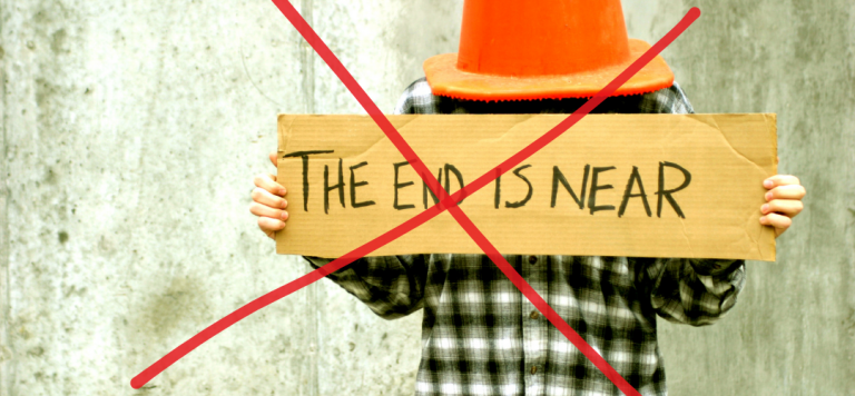 person with cone on head holding "the end is near" sign with X - The Sky is Not Falling Blog
